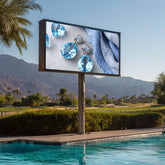 Outdoor digital display screen showing jewelry near a pool with mountains in the background